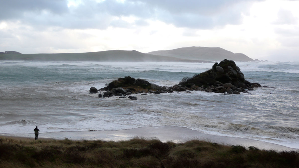 Beach and Pene Rock in stormy seas