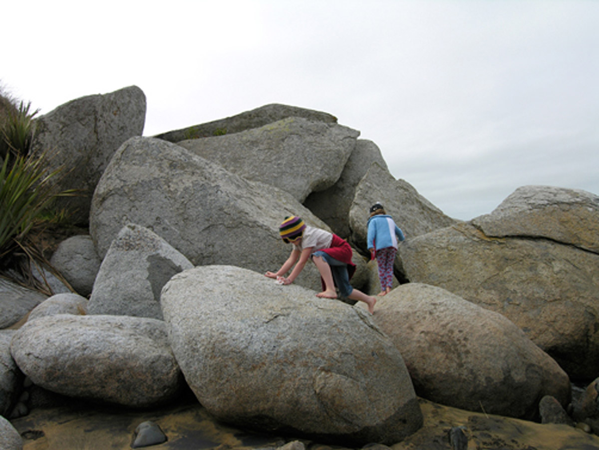 Granddaughters Vita and Poppy climb on the sculptured rocks, Cosy Nook